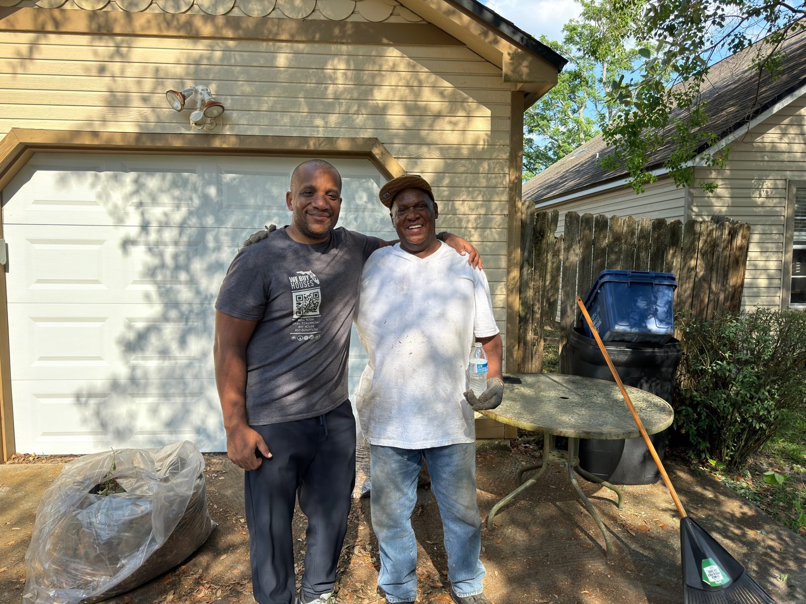 Chris Moore with a homeowner outside their home